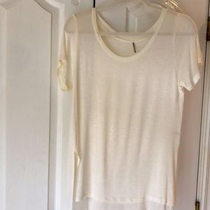 Women’s semi sheer cream colored tea. Size medium